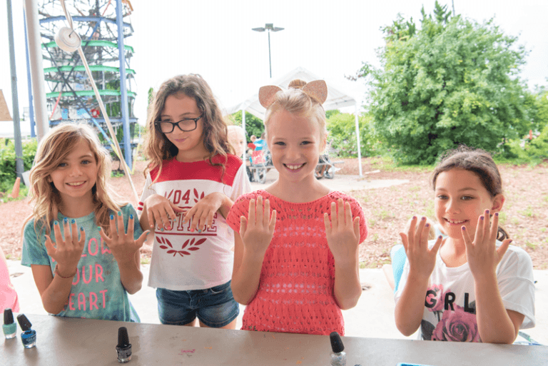 female campers getting their nails painted