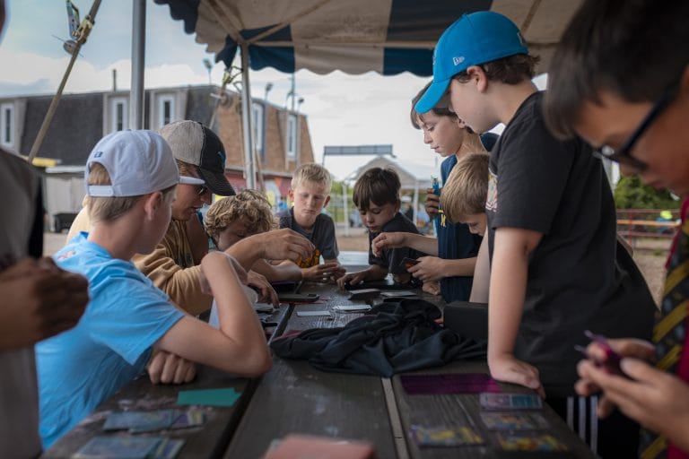boys playing pokemon card game at camp